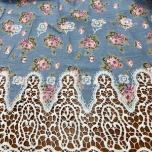 DC22 - Chambray - Stunning !! Light Pink Flowers on a Pale Blue Chambray Base with a Lace Bottom Border and Lace Rosettes scattered over fabric - 100% Cotton - 135cm wide - $24.00 per mtr