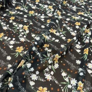P262 - 100% Polyester - Chiffon - Black with a white and yellow meadow flowers - 150cm wide - $20.00 per mtr